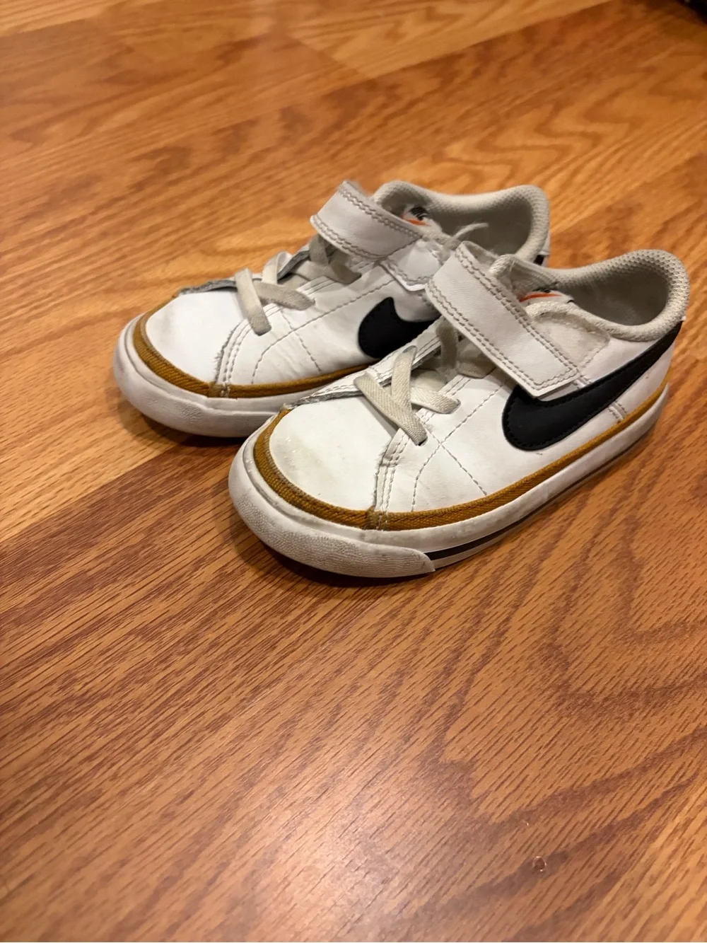 Nike Kids White Sneakers with Black Swoosh and Brown Accent